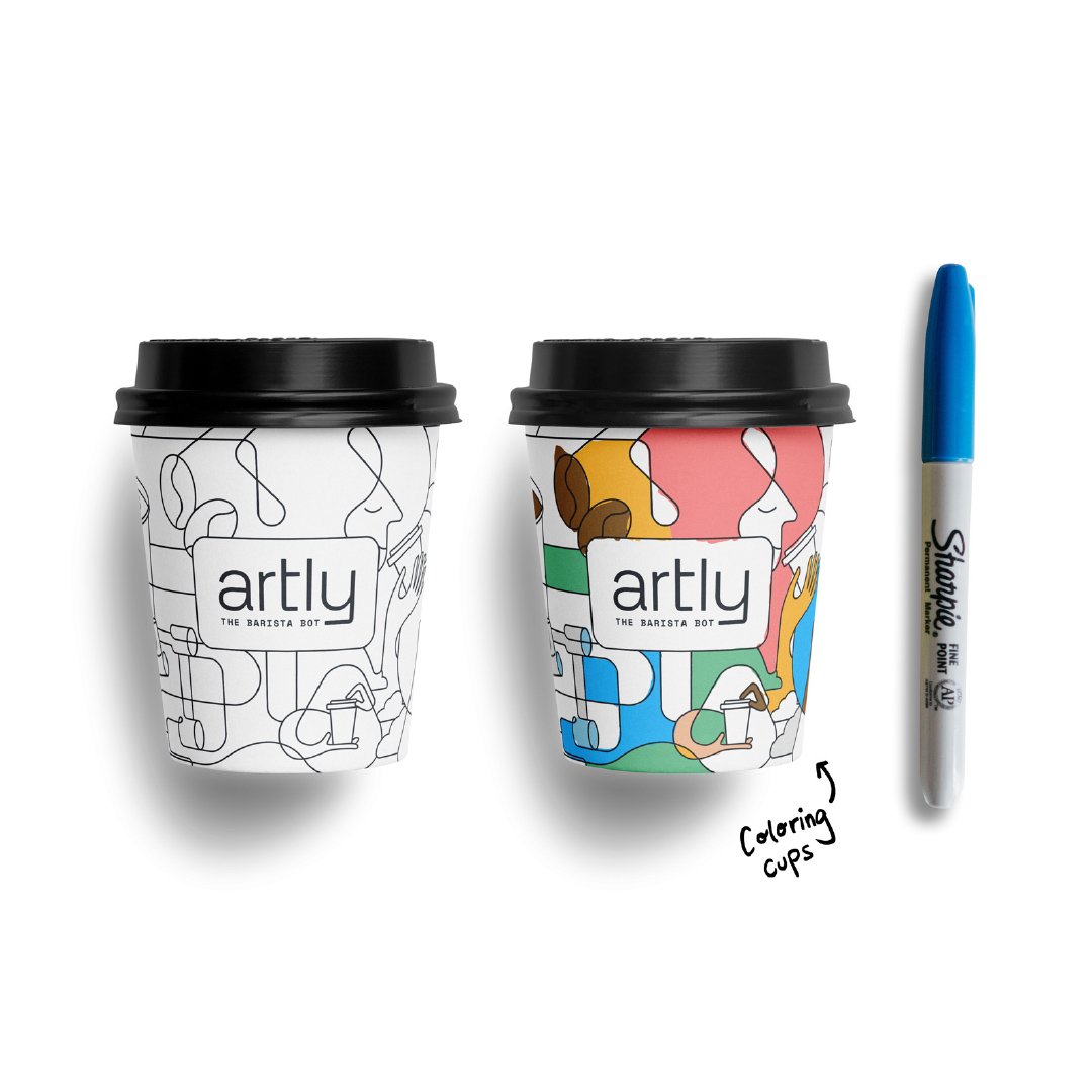 Two coffee cups with line drawings are side-by-side with a blue Sharpie. The cup to the left has the black and white line illustration. The cup to the right has the same illustration, but it’s partially colored in.