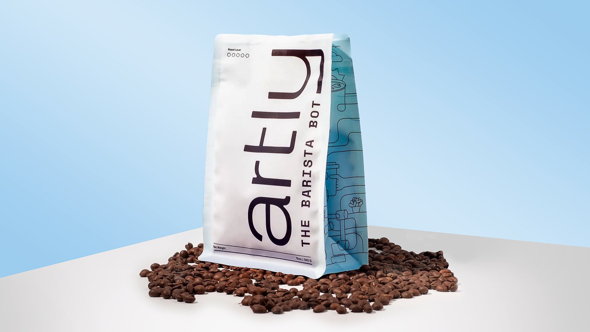 An white coffee bag sits on top of coffee beans on a white table with a blue background. The Artly logo is on the front with the side of the bag showcasing line drawings over a blue background.