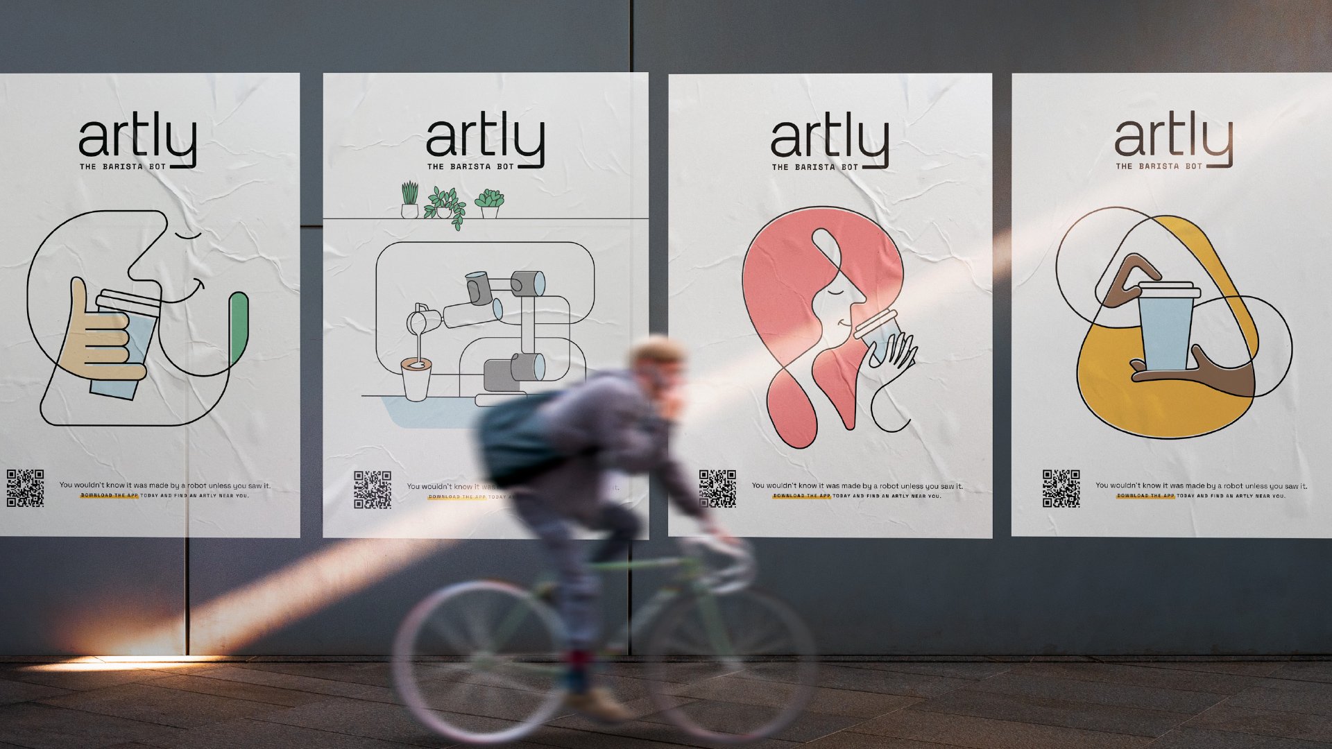 A bicyclist rides quickly by four of Artly’s illustrated posters.
