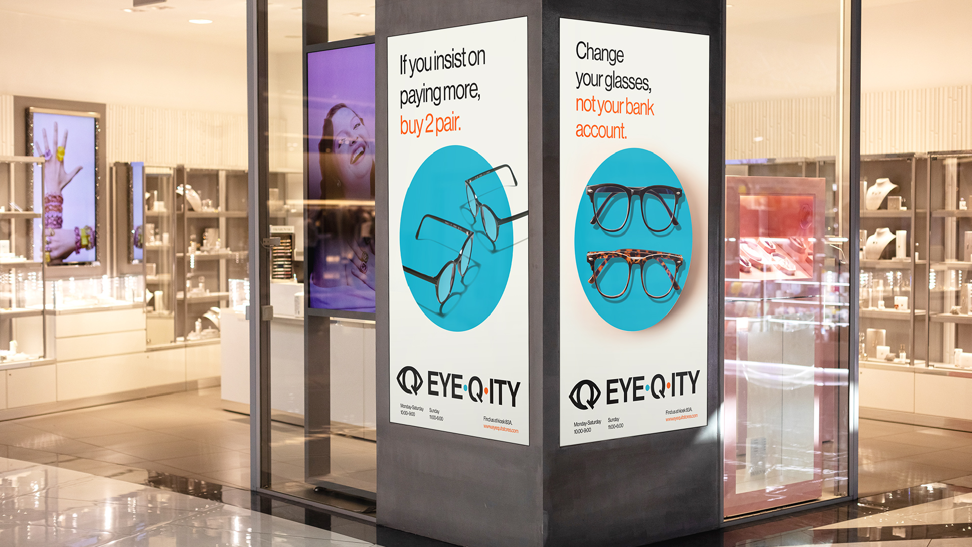 Two posters sit on either side of a storefront pillar. Both ads feature two pairs of glasses. One ad says, “If you insist on paying more, buy 2 pair.” The second ad says, “Change your glasses, not your bank account.”